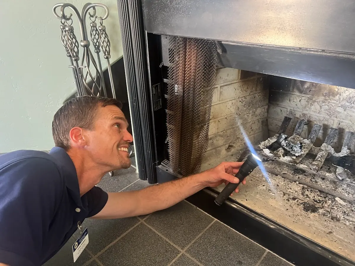 Lonny inspecting a fireplace.