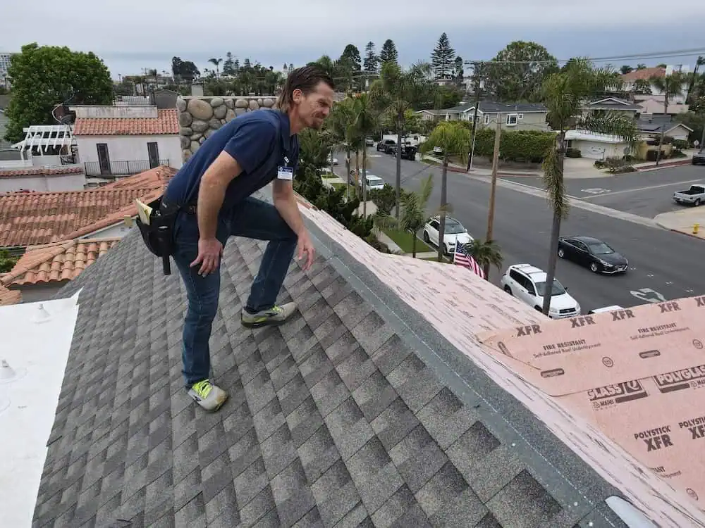 Lonny Inspecting a house in San Diego on a roof.